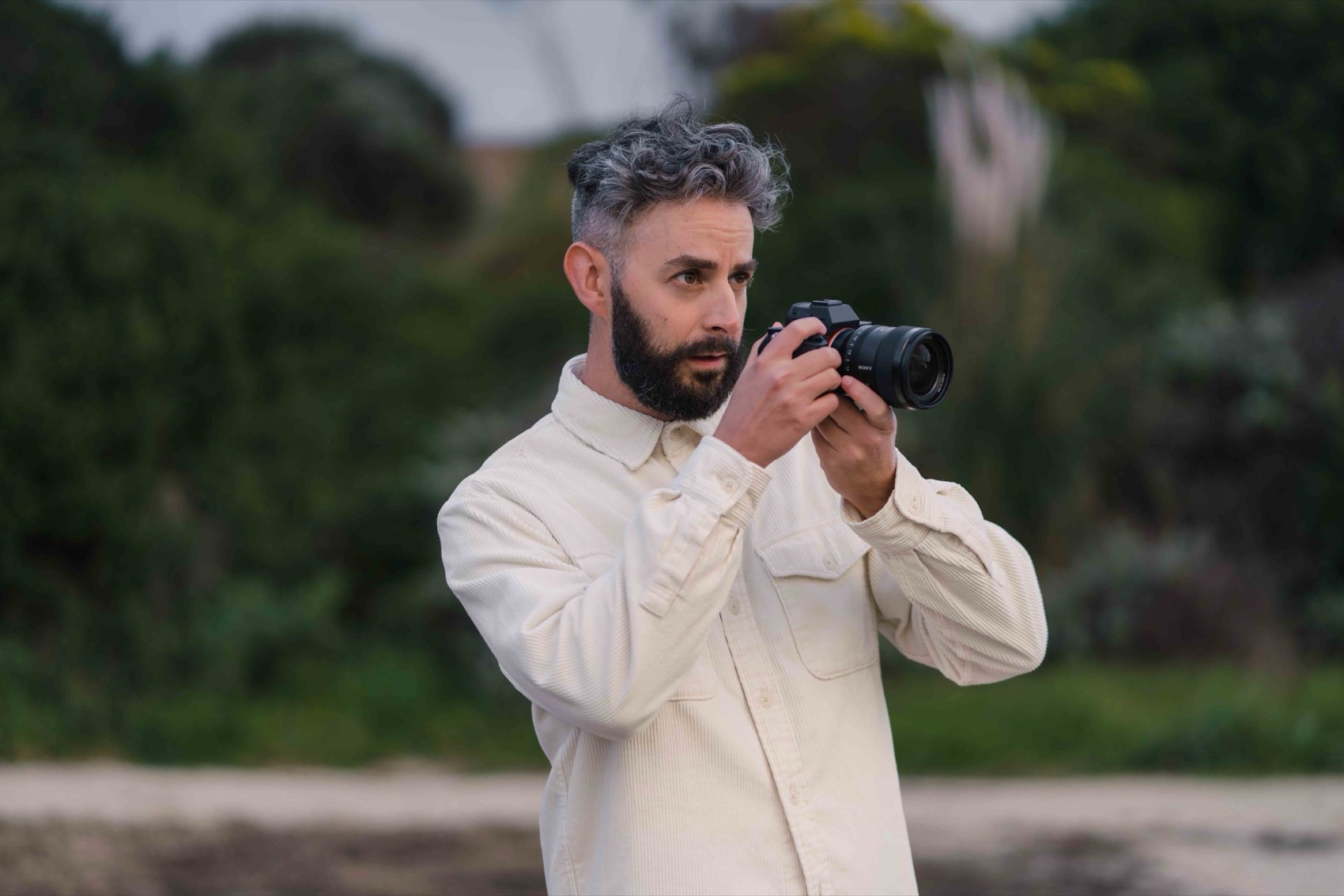 Matt Roberts holding a camera outdoors