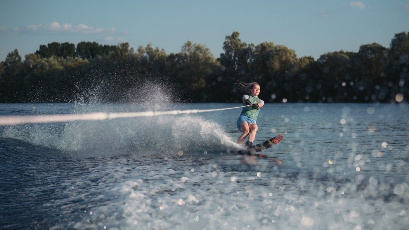 A waterskier carving a turn across the water