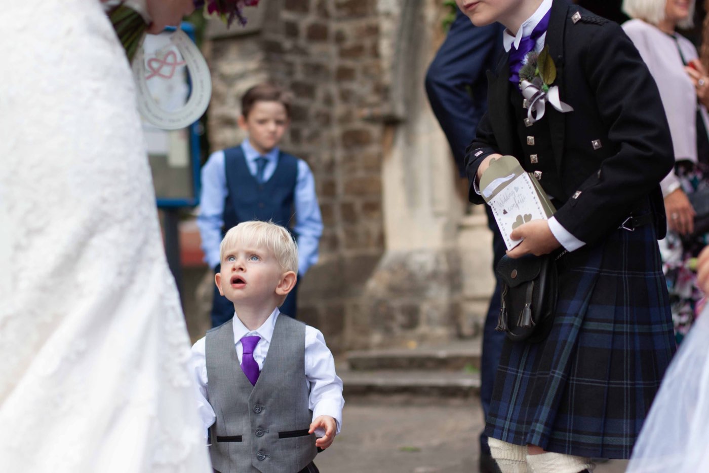 A candid moment with a young ring bearer at a wedding